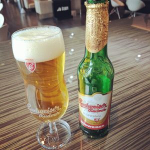 a glass of beer next to a bottle