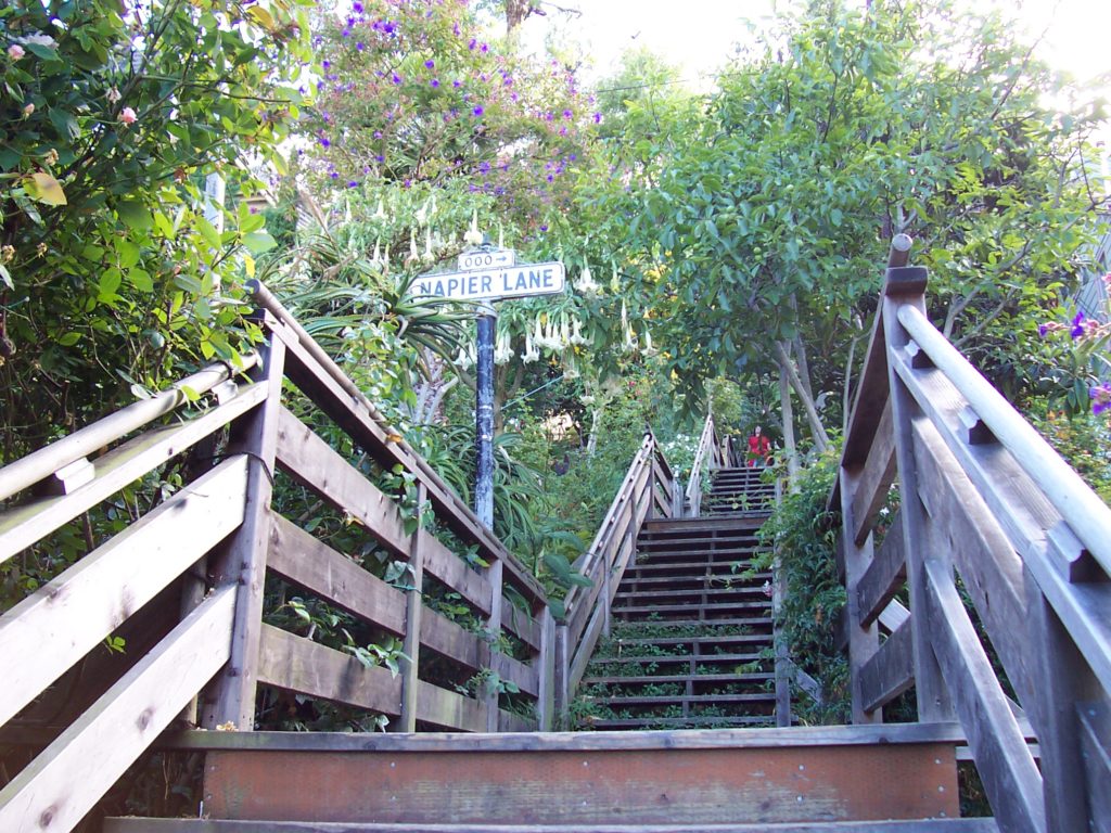 a wooden stairs leading to a sign