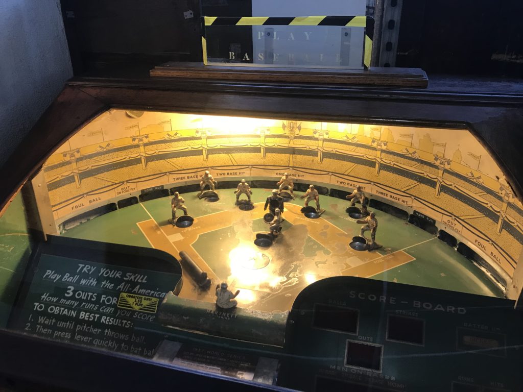 a toy baseball game in a glass case