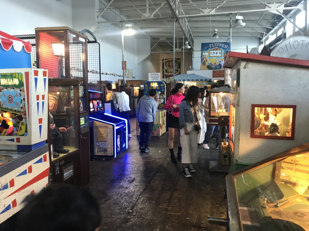 a group of people in a room with arcade games