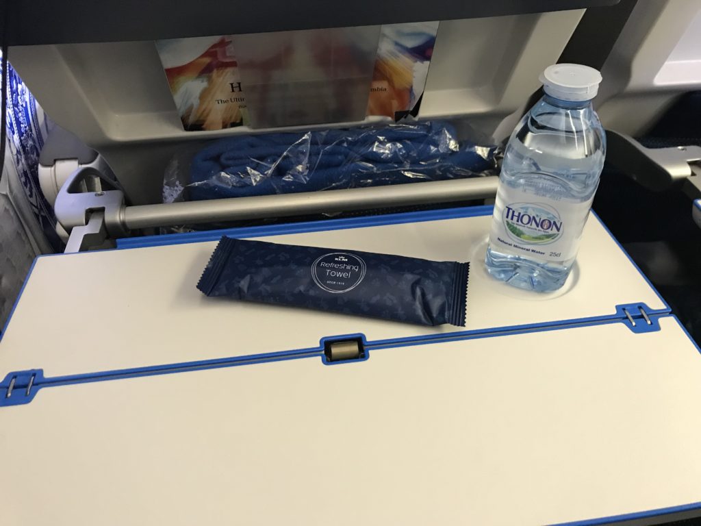 a bottle of water and a packet of water on a table