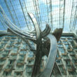 a sculpture in front of a glass roof