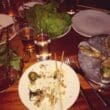 a table with plates of food and utensils