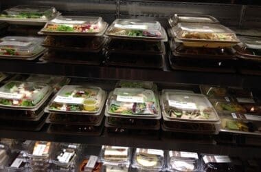 a shelf with food in plastic containers