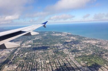 an airplane wing and land and water