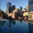 a pool with a city skyline in the background