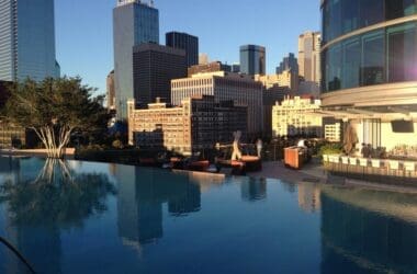 a pool with a city skyline in the background