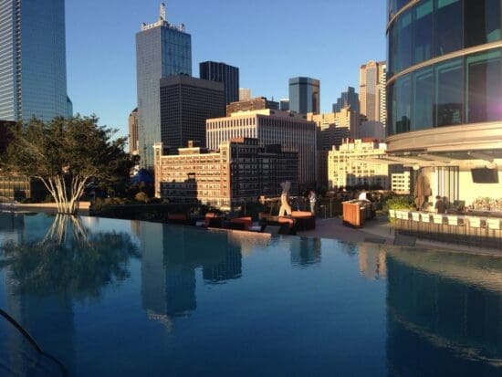 a pool with a city skyline in the background