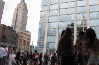 a group of people standing around a pool