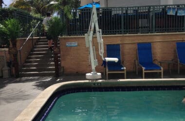 a pool with a umbrella and a person in the back