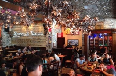 a group of people sitting at tables in a restaurant