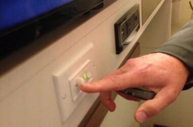 a hand turning on a switch