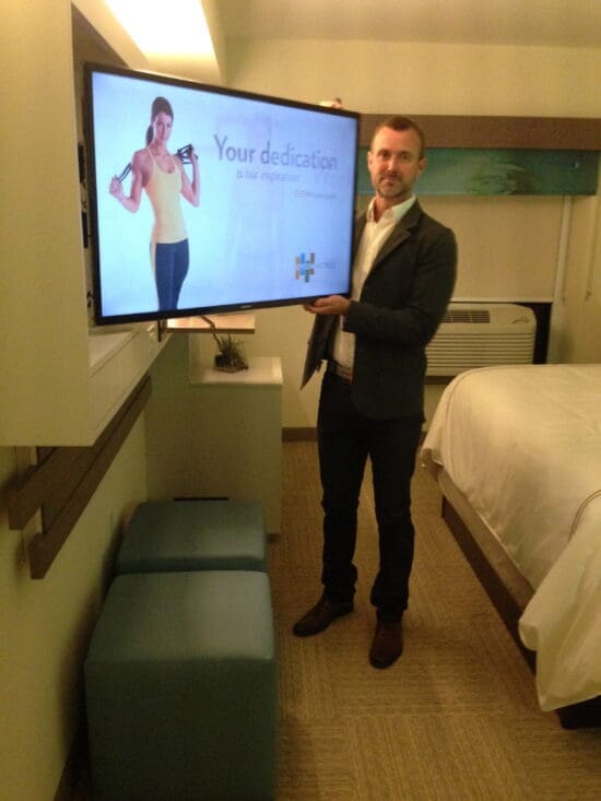 a man holding a large television