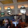 a group of people sitting at tables in a restaurant