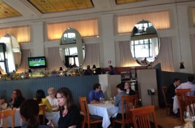 a group of people sitting at tables in a restaurant