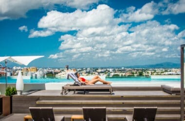 a woman lying on a lounge chair by a pool