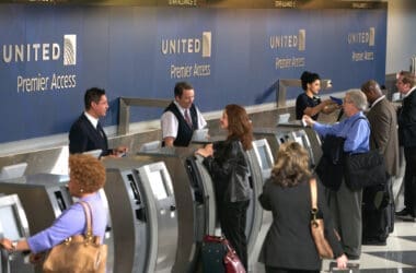 a group of people standing around an electronic machine