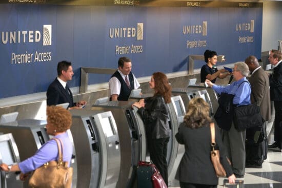 a group of people standing around an electronic machine