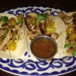a plate of tacos with sauce