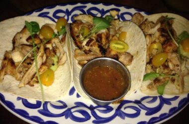 a plate of tacos with sauce