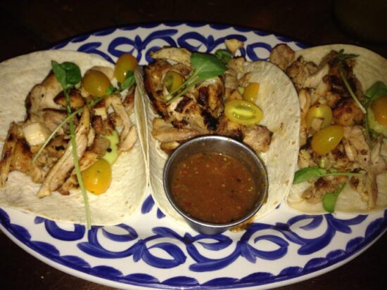 a plate of tacos with sauce