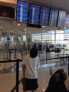 Our son Joaquin looks up at the departures board on a recent flight. Photo by Barb DeLollis.