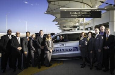 a group of people standing next to a car