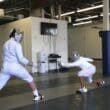 two people in fencing gear