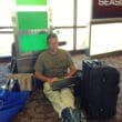 a man sitting on the floor with his laptop