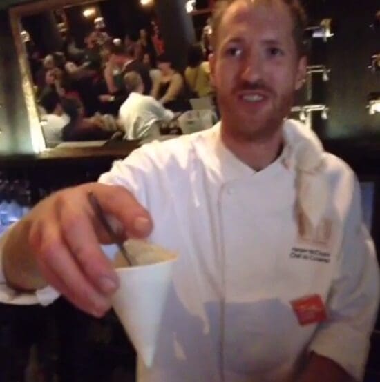 a man holding a cup with spoon