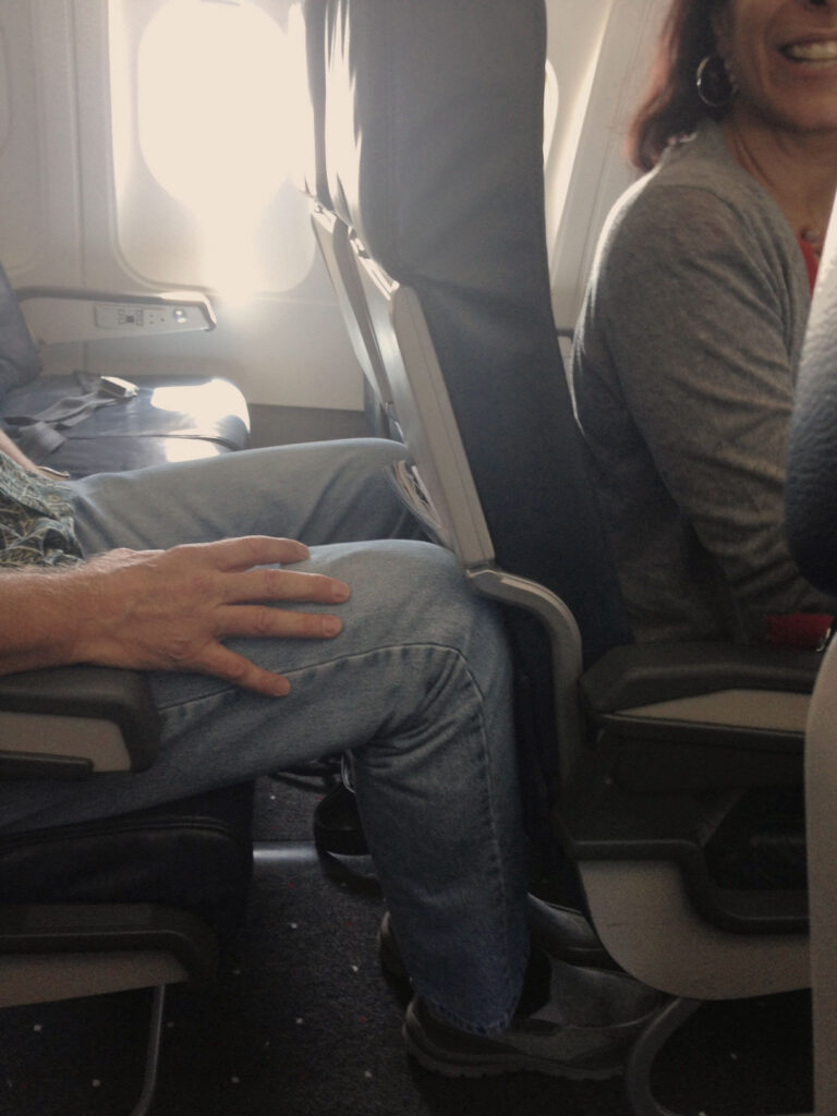 A close-up shot of Mark's knees that "defended" his space when I tried to recline.