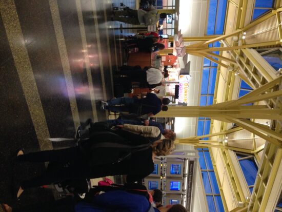 people standing in a line at an airport