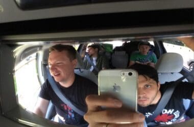 a group of men in a car taking a selfie