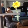 a woman taking a selfie with a yellow flower