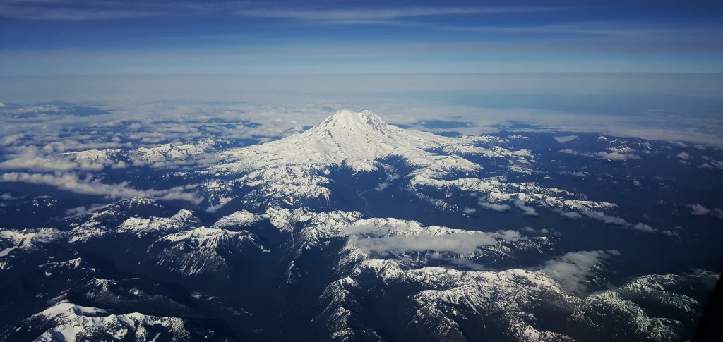 A mountain with snow on top as seen from an Alaska Airlines Embraer E175 passenger aircraft while on approach to Portland International Airport (PDX)