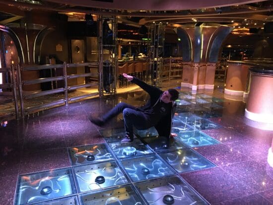 a man in a black jacket on a shiny floor