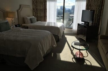 a room with two beds and a television
