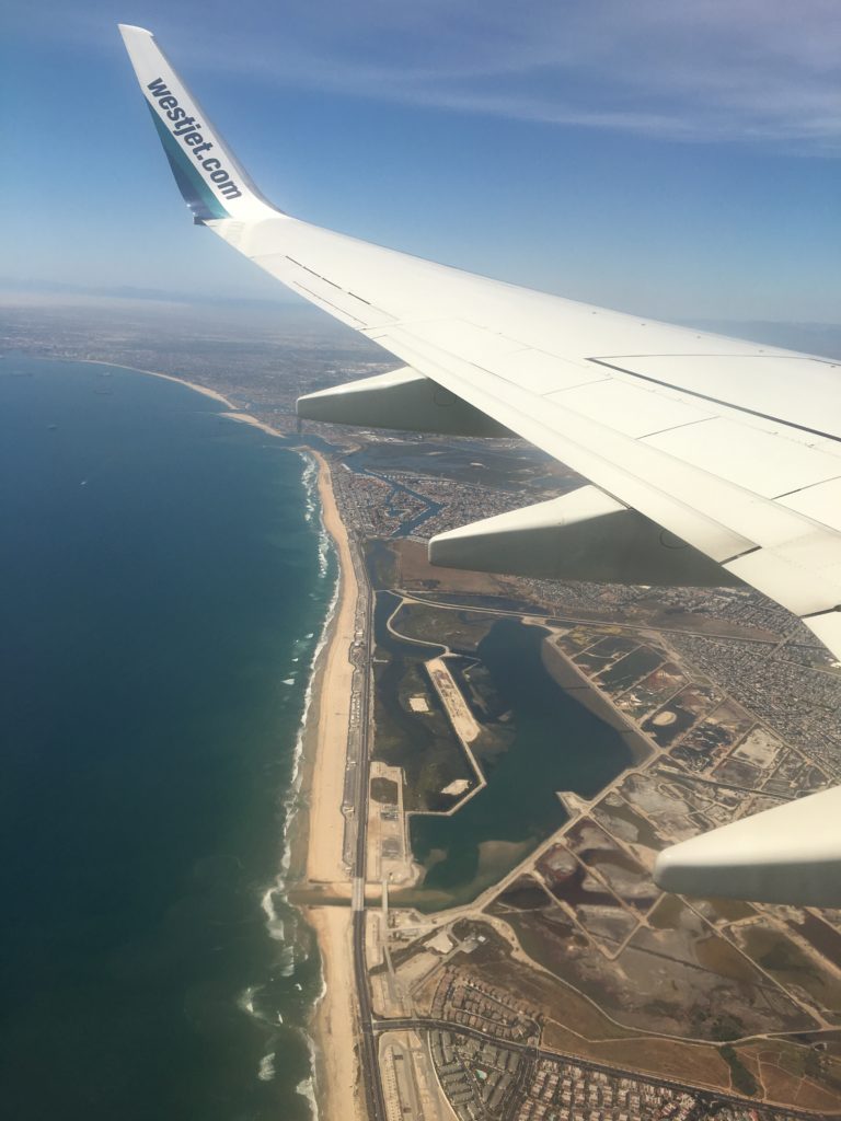 an airplane wing above a body of water