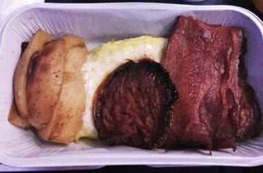 a tray of food with meat and potatoes