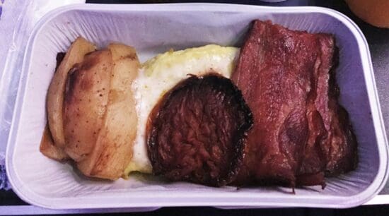 a tray of food with meat and potatoes