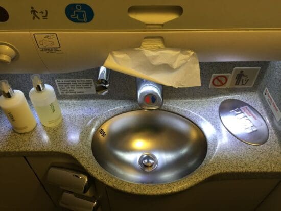 a sink with a faucet and a toilet paper on it