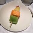 a plate of fruit on a stick