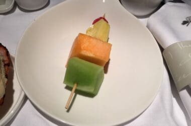 a plate of fruit on a stick