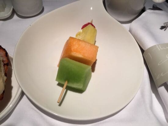 a plate of fruit on a stick