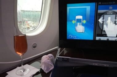 a glass of wine on a table in an airplane