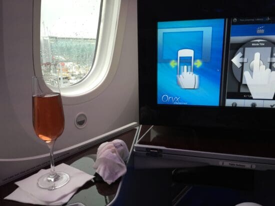 a glass of wine on a table in an airplane