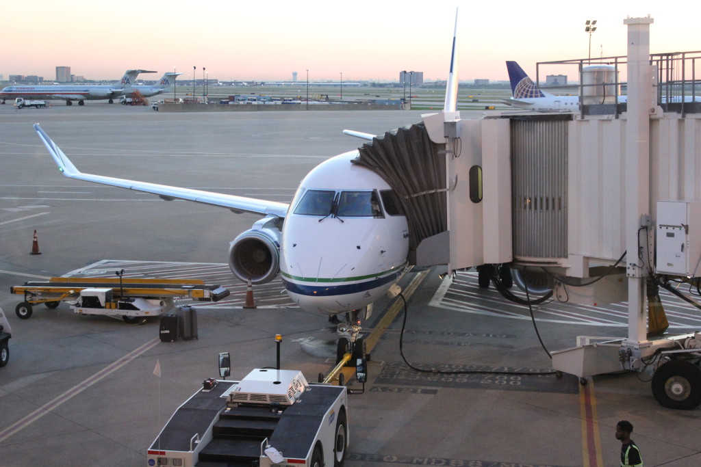 An Alaska Airlines E175 parked at a gate at Dallas-Fort Worth International Airport.