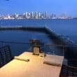 a table with chairs and a city in the background