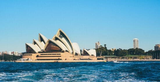 Sydney Opera House with pointed roof and a body of water