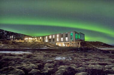 a building with green lights in the sky